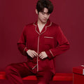 Red polyester wedding dowry suit set for a man and woman, featuring long sleeves and trousers.