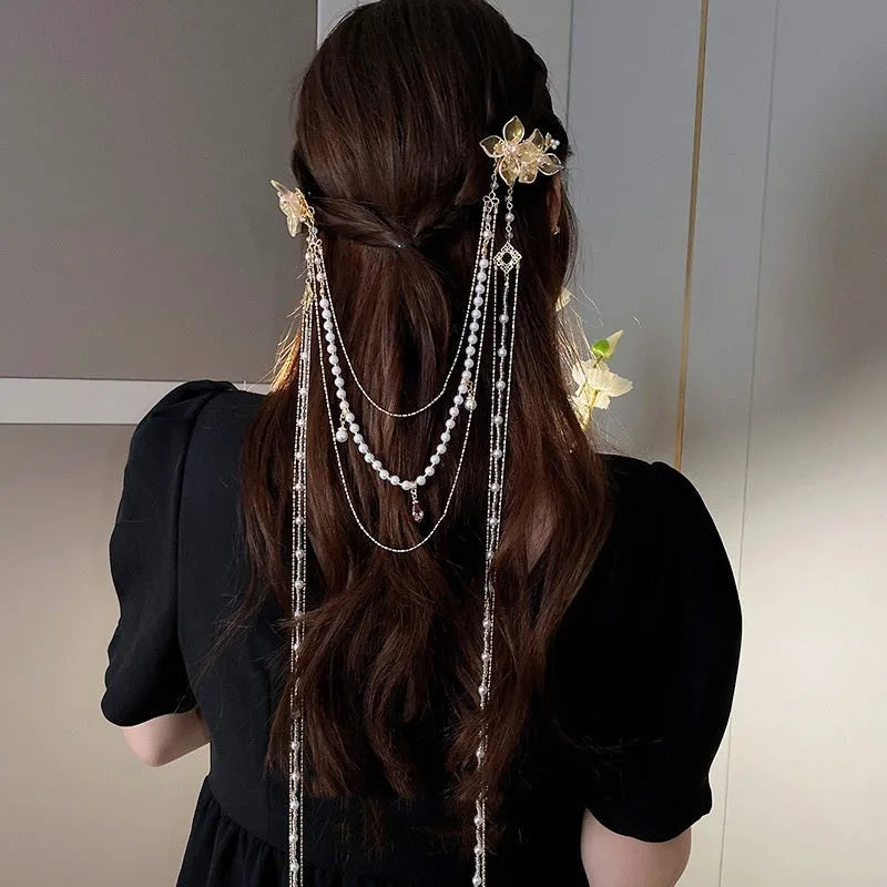 Gold women's hairpin with diamond flower design and long acrylic tassels