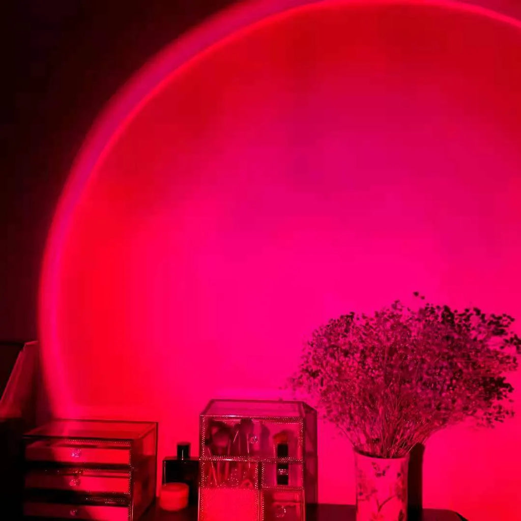 Rechargeable sunset projection lamp showing rainbow colour effects with USB cable