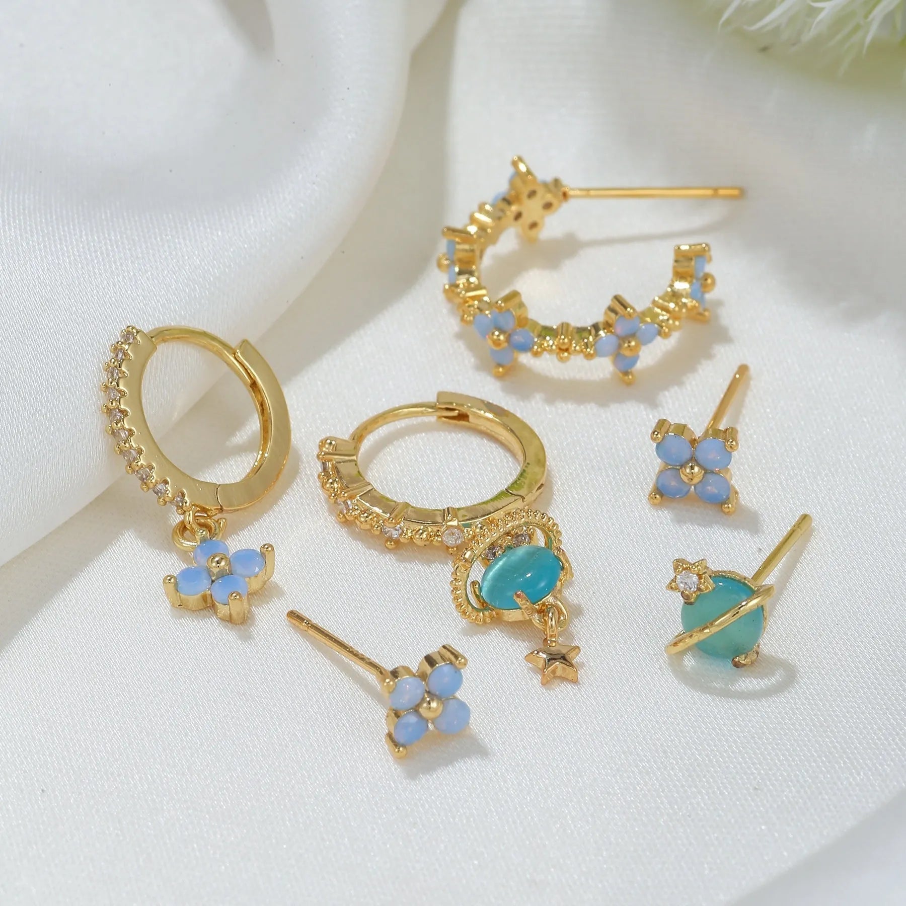 Gold and silver flower stud earrings with zircon stone mosaic centre.