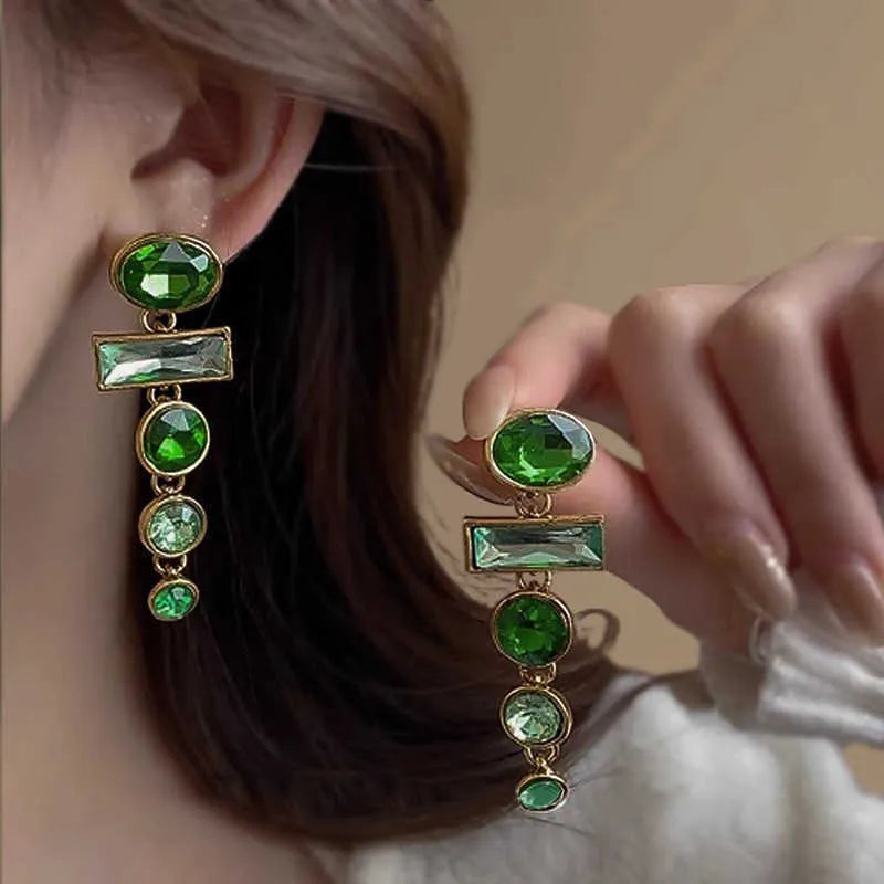 A pair of women's green gradient alloy drop earrings with a geometric tassel design and inlaid zircon stone.