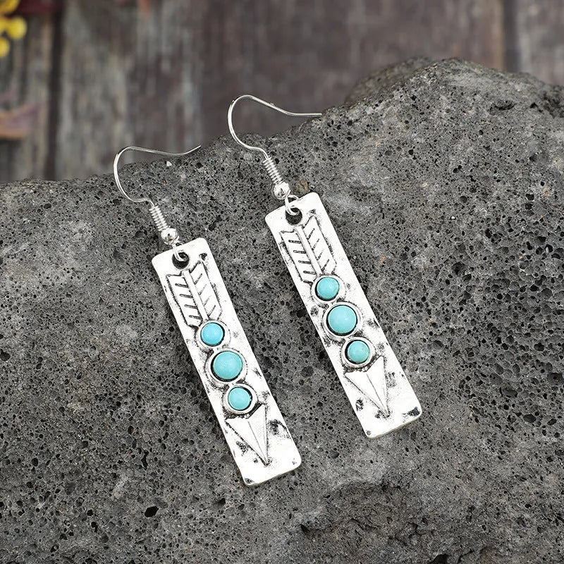 Silver geometric drop earrings with turquoise stone inlay on long strip design