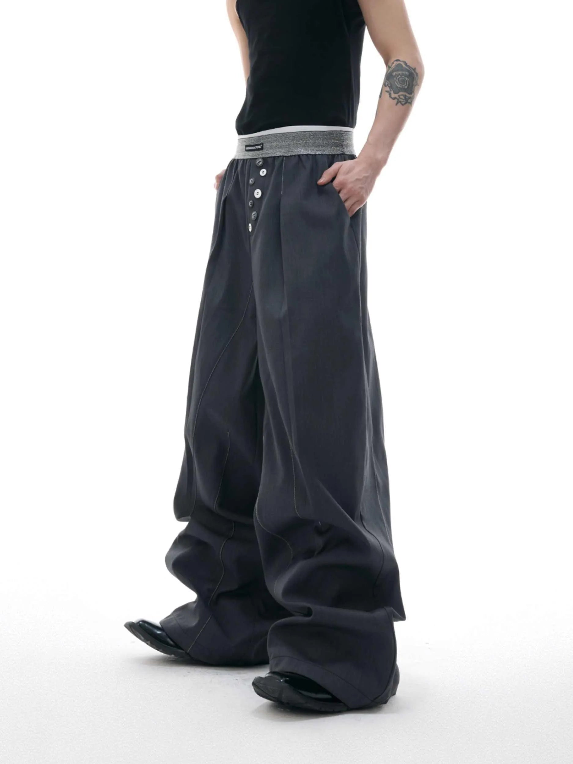 Drooping straight-leg casual trousers with button open line detail in black or grey colours