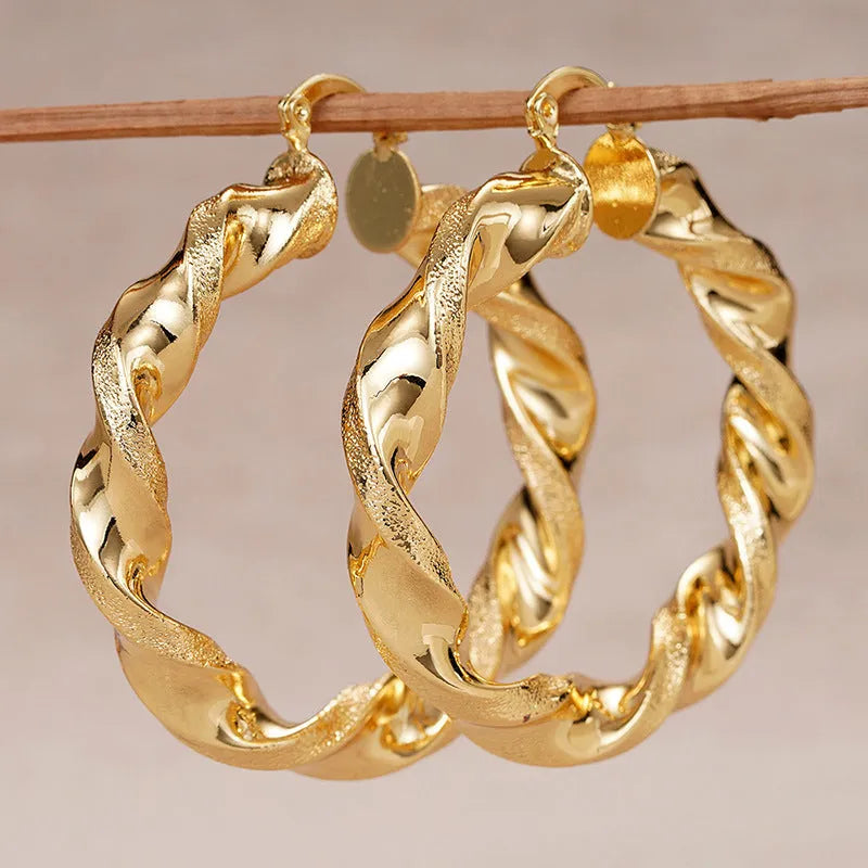 Geometric drop-shaped ear clips with ring and line design in metallic finish