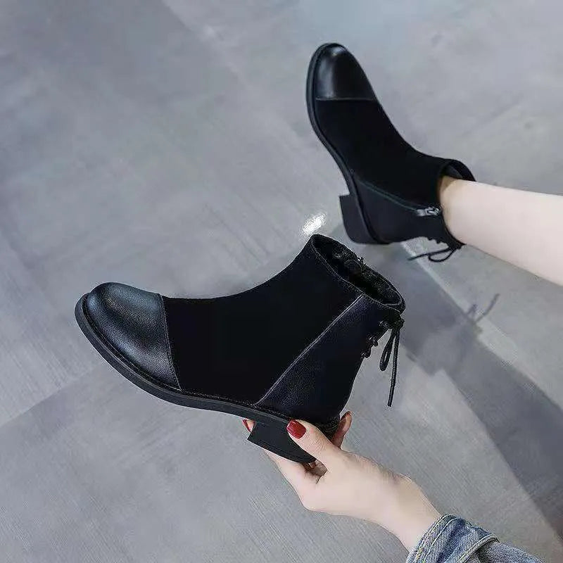 Women's black knee-high Martin boots with side zip and decorative bow detail