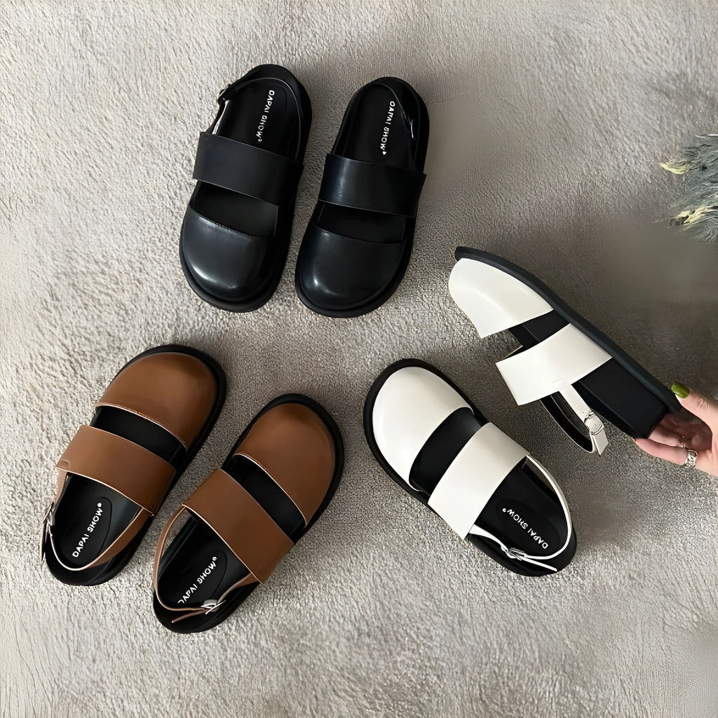 Retro brown platform sandals with a single ankle strap buckle and closed round toe.