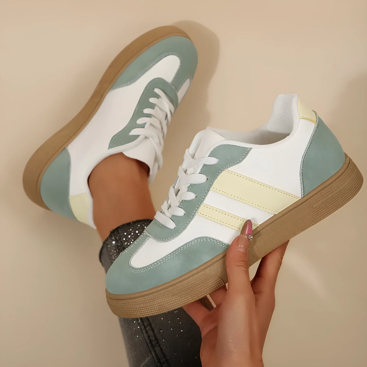 Green women's retro sports shoes with white cross straps and a low flat heel