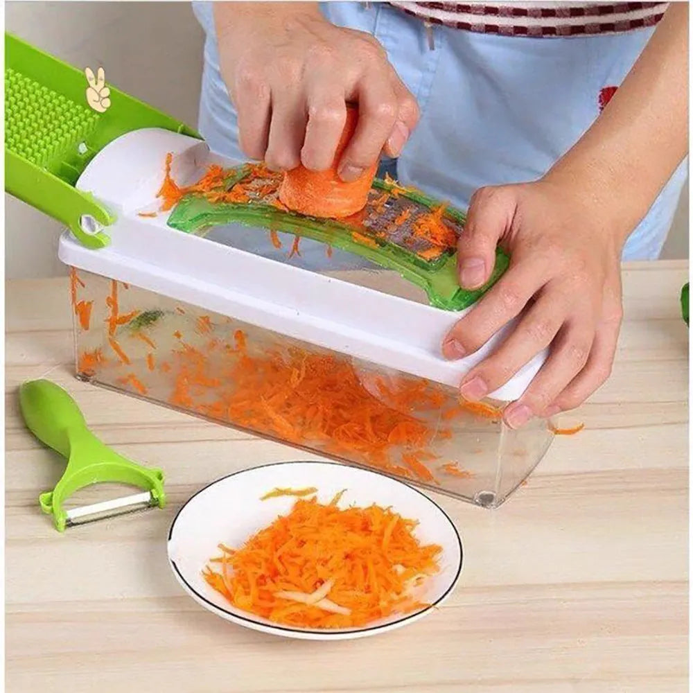 Green manual food chopper with multiple stainless steel accessories on a kitchen counter.