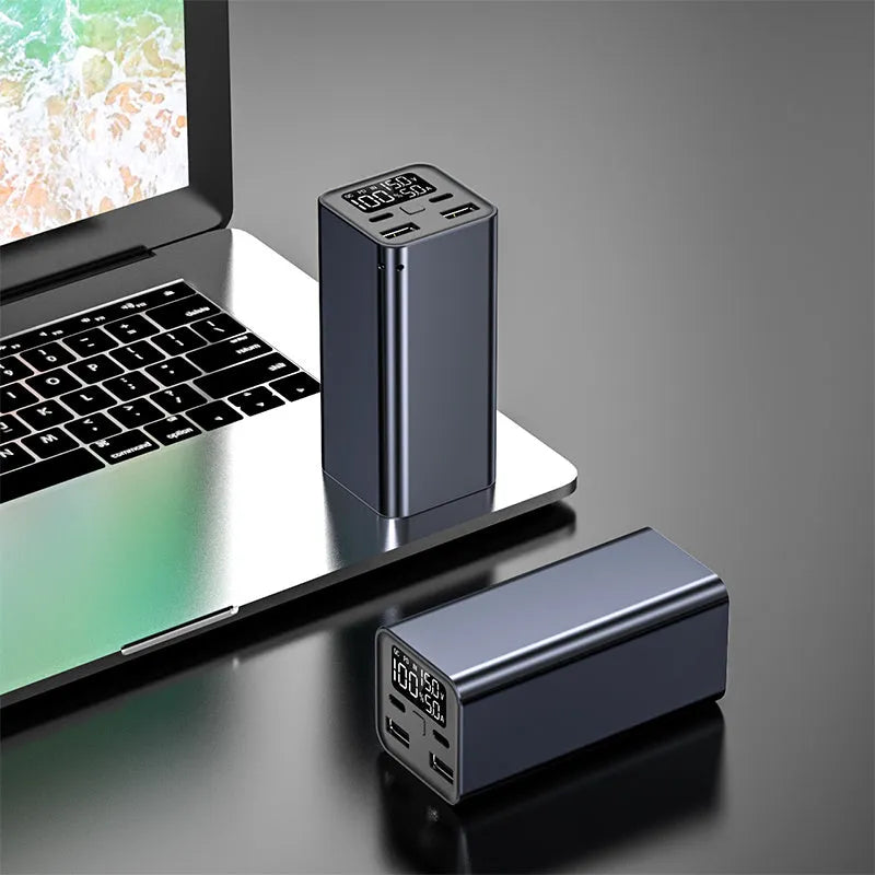 65W laptop charging bank with metal housing in black, blue or grey colours showing dimensions 47.5x104.5x47.5mm