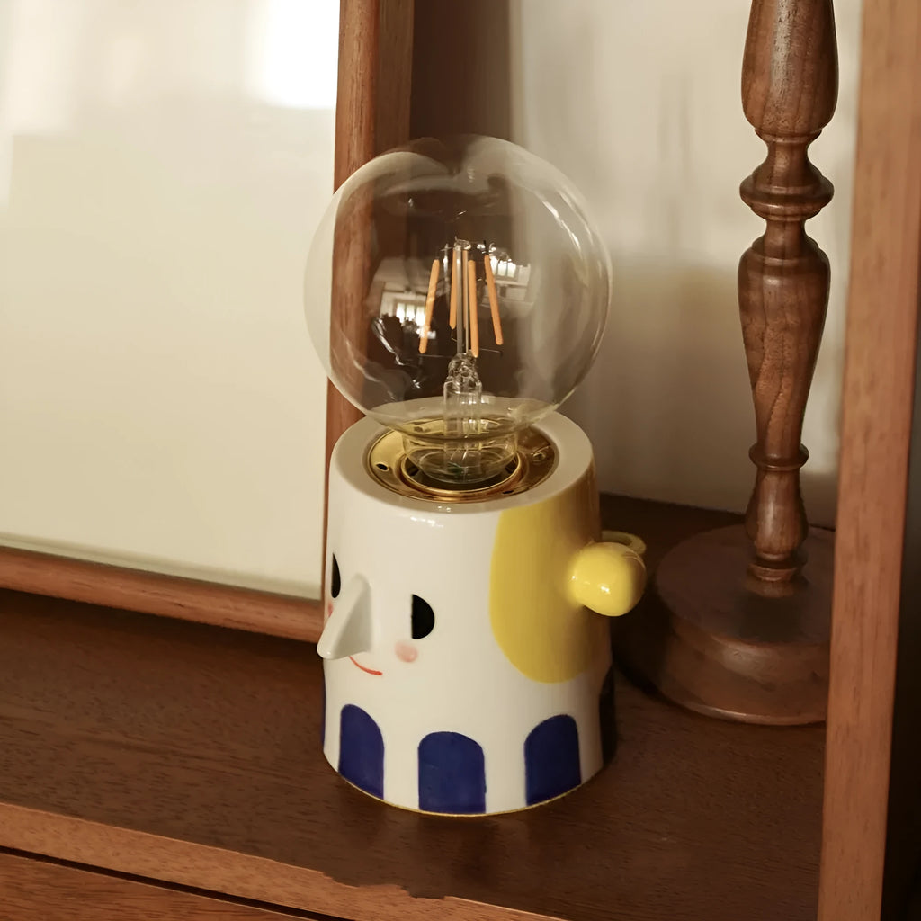 Handmade ceramic table lamp with ball headlight design on bedside table