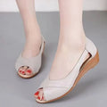 Women's black peep toe sandals with an ankle buckle and a mid rubber heel.
