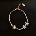Gold-coloured copper bracelet with zircon inlay and quadrilateral geometric design