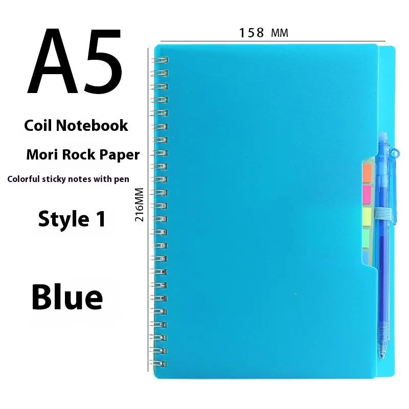 Erasable coil notebook with stone paper, showing a black cover option and a pen on a wooden desk.