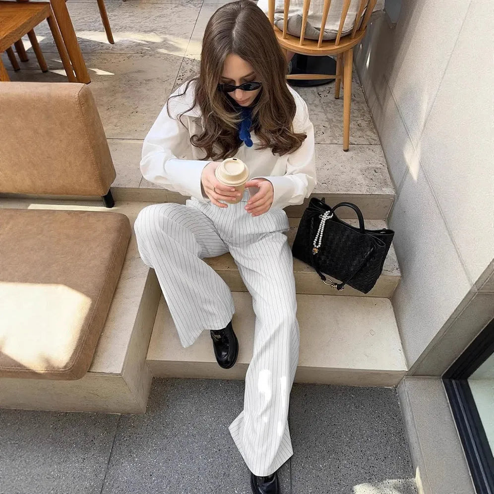 White striped women's wide-leg trousers with zip fastening and loose casual fit