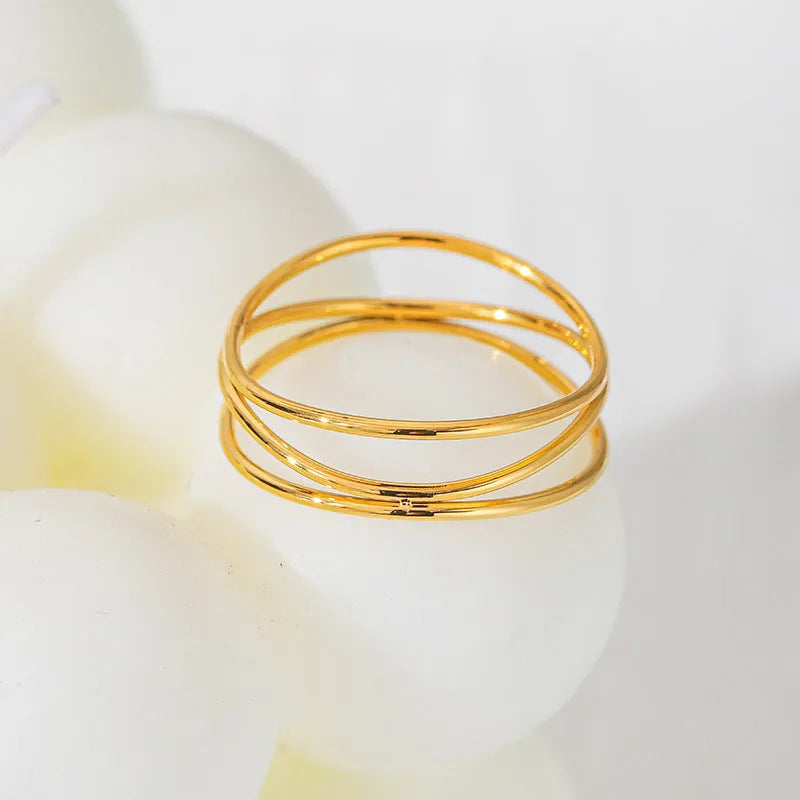 Geometric three-layer coil ring with gold electroplated finish on titanium steel