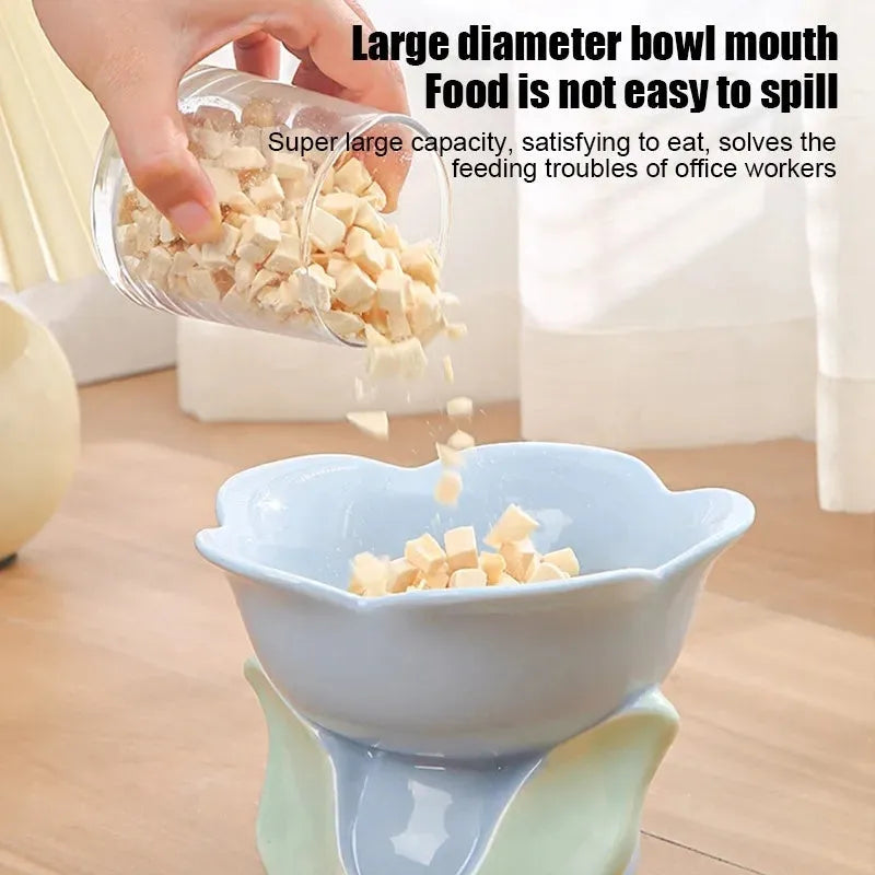 Blue ceramic raised pet bowl with floral pattern and non-slip base for cat or small dog.