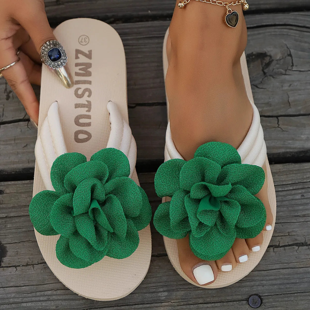 Women's plus size floral flip flop slippers in solid green colour, showing round toe shape