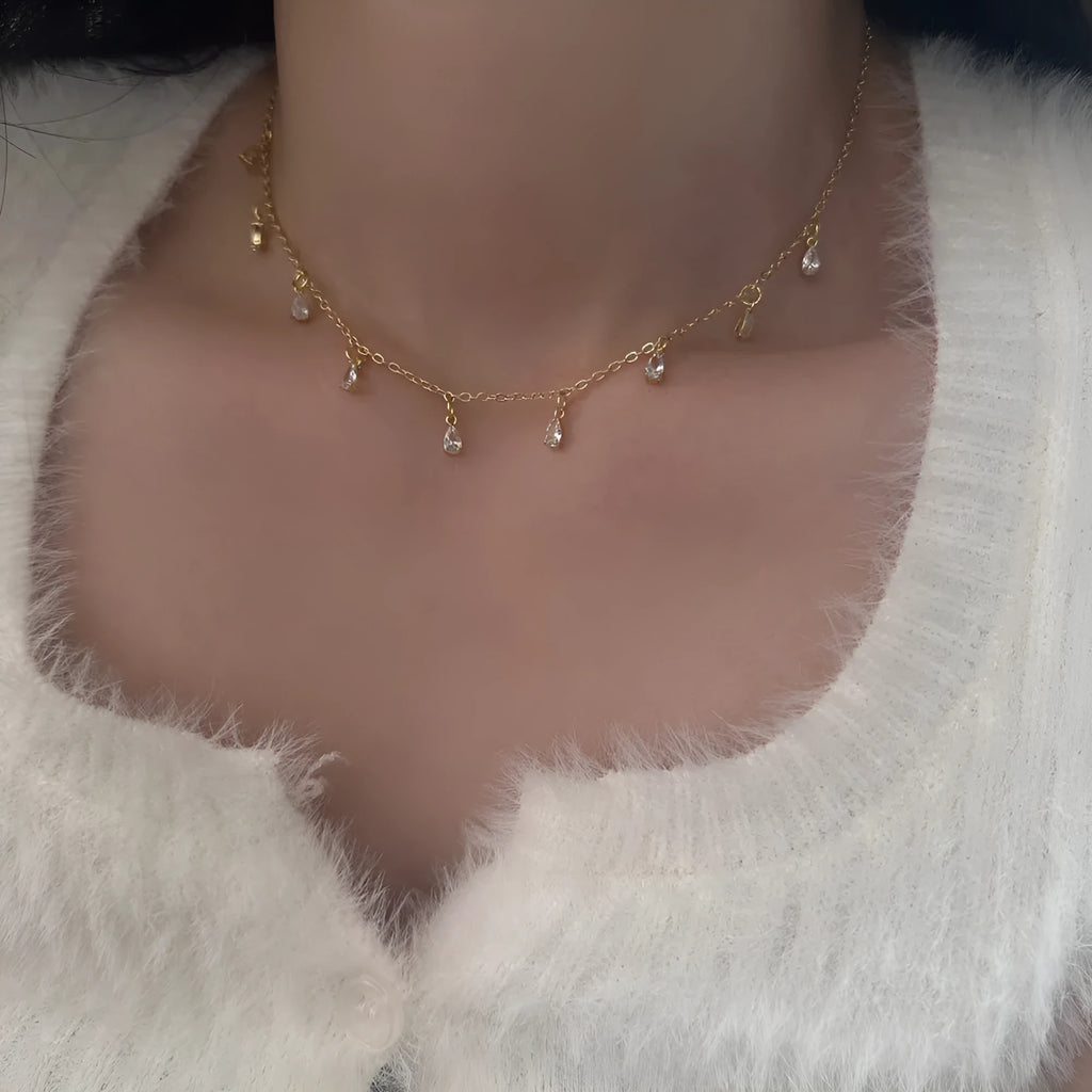 Zircon jewellery set with geometric pendant necklace, matching earrings, and anklet in silver-tone chain