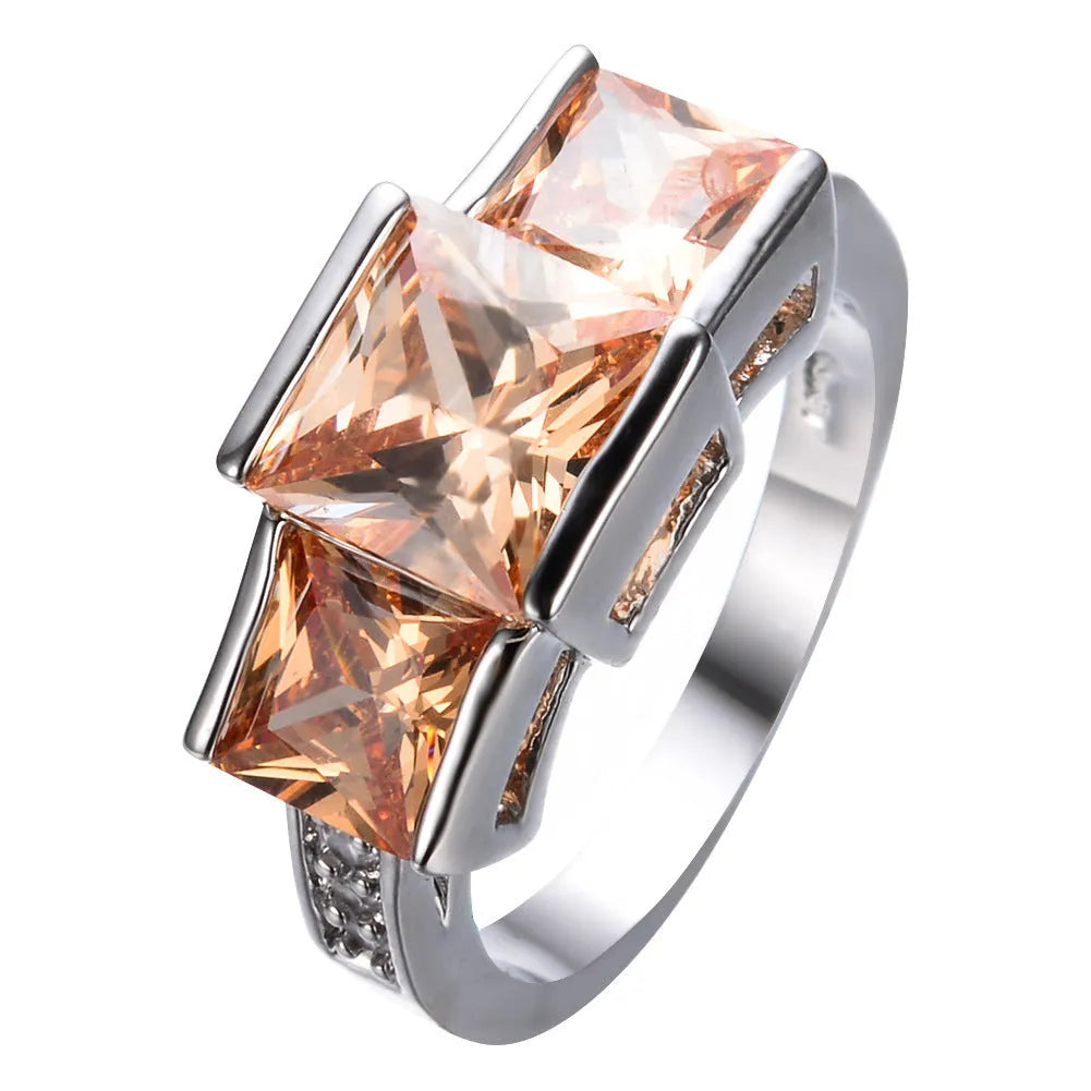 A geometric copper ring in multiple colour options on a size chart showing rings 6 to 10.