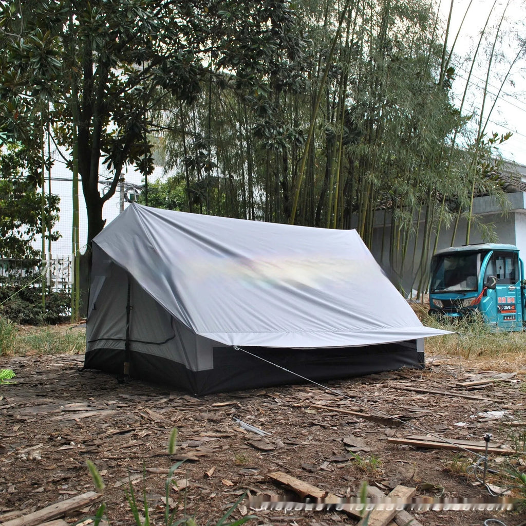 Brown and white pole-free A-line cabin tent set up with hiking canes, showing spacious interior