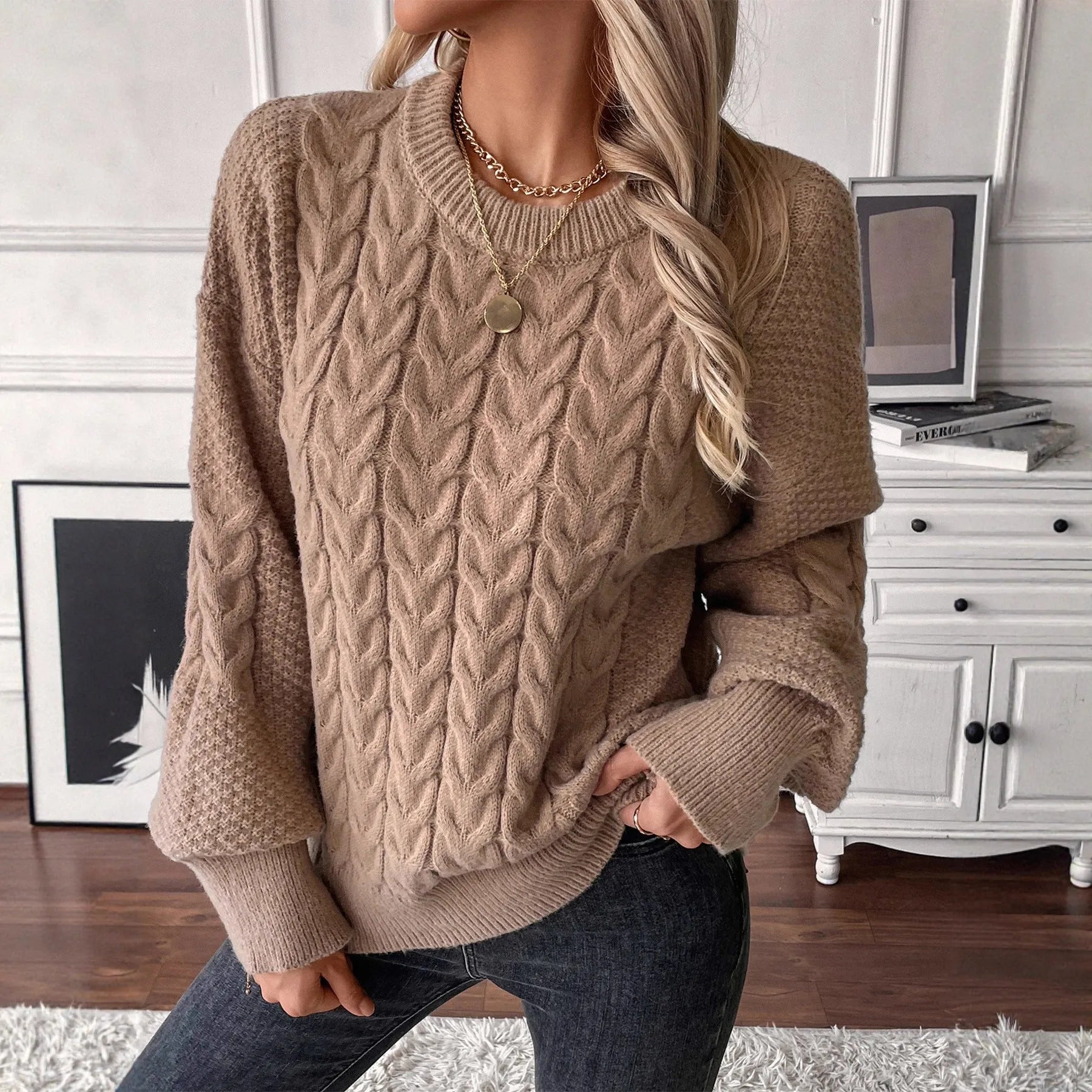 Women's loose beige round neck casual sweater with textured thread detail on a hanger.