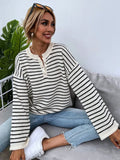 Black striped women's casual top with drop-shoulder sleeves on hanger