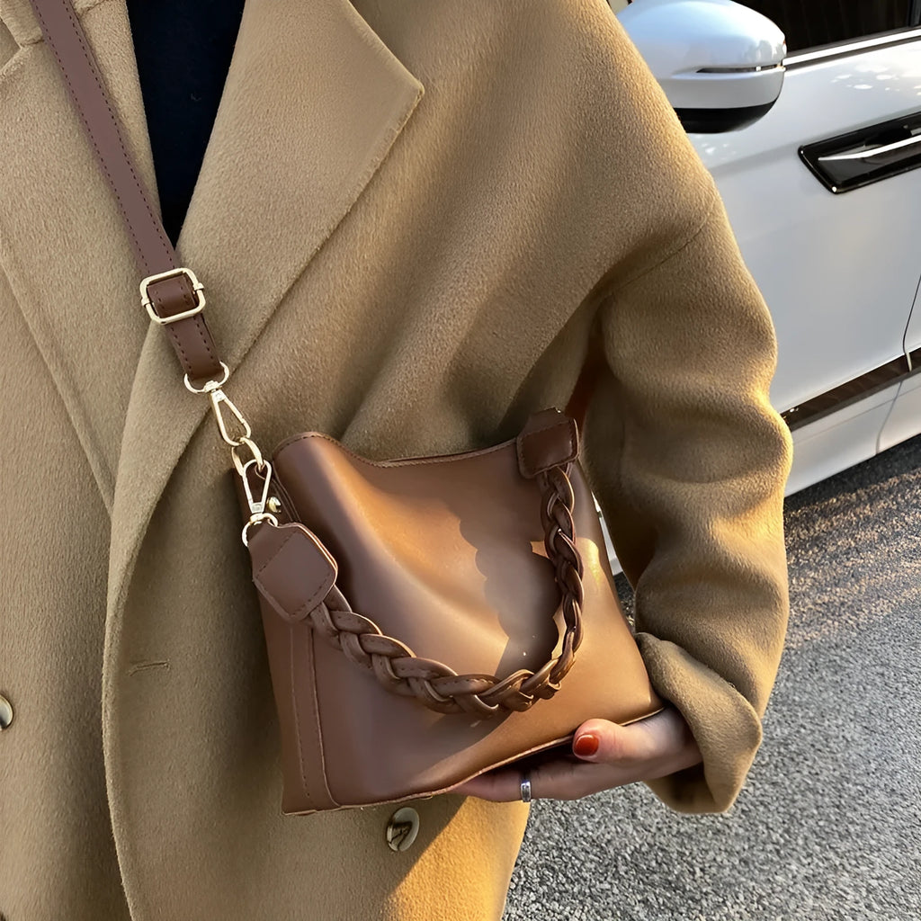 Unisex one-shoulder crossbody bucket bag in woven PU leather, shown in khaki colour.