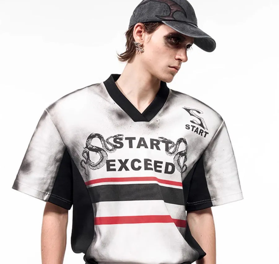 Women's short sleeve V-neck top with a grey letter snake pattern print and padded shoulders.