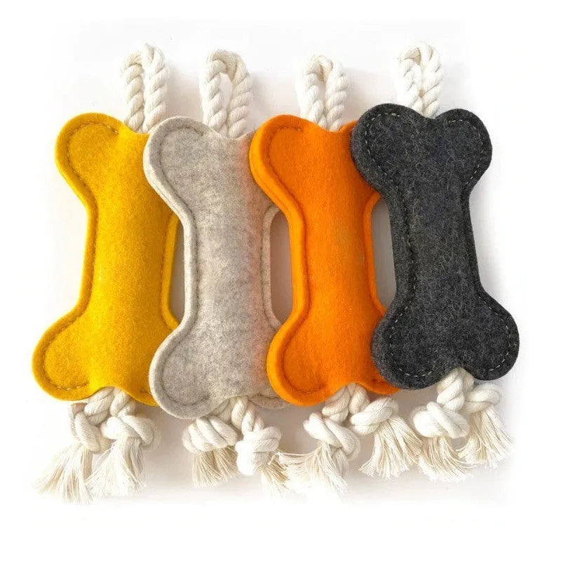 Bone-shaped felt dog chew toy with rope knot interior in blue, shown next to a tape measure indicating 16 cm length.