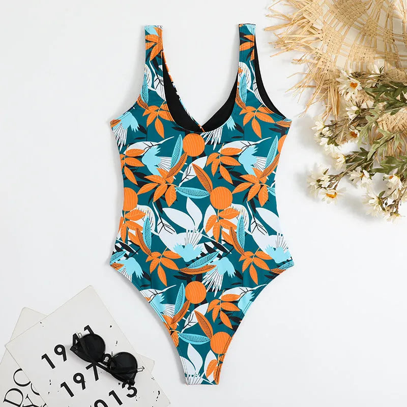 Women's high-waist one-piece swimsuit in a printed pattern, showing conservative cut and style.