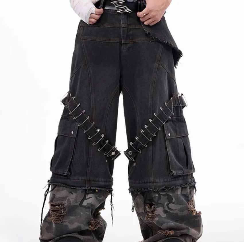 Men's grey camouflage pattern jeans with spliced panels and decorative pin details.