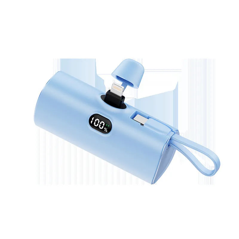 Compact capsule-shaped digital display power bank with integrated USB plug, shown in multiple colours.