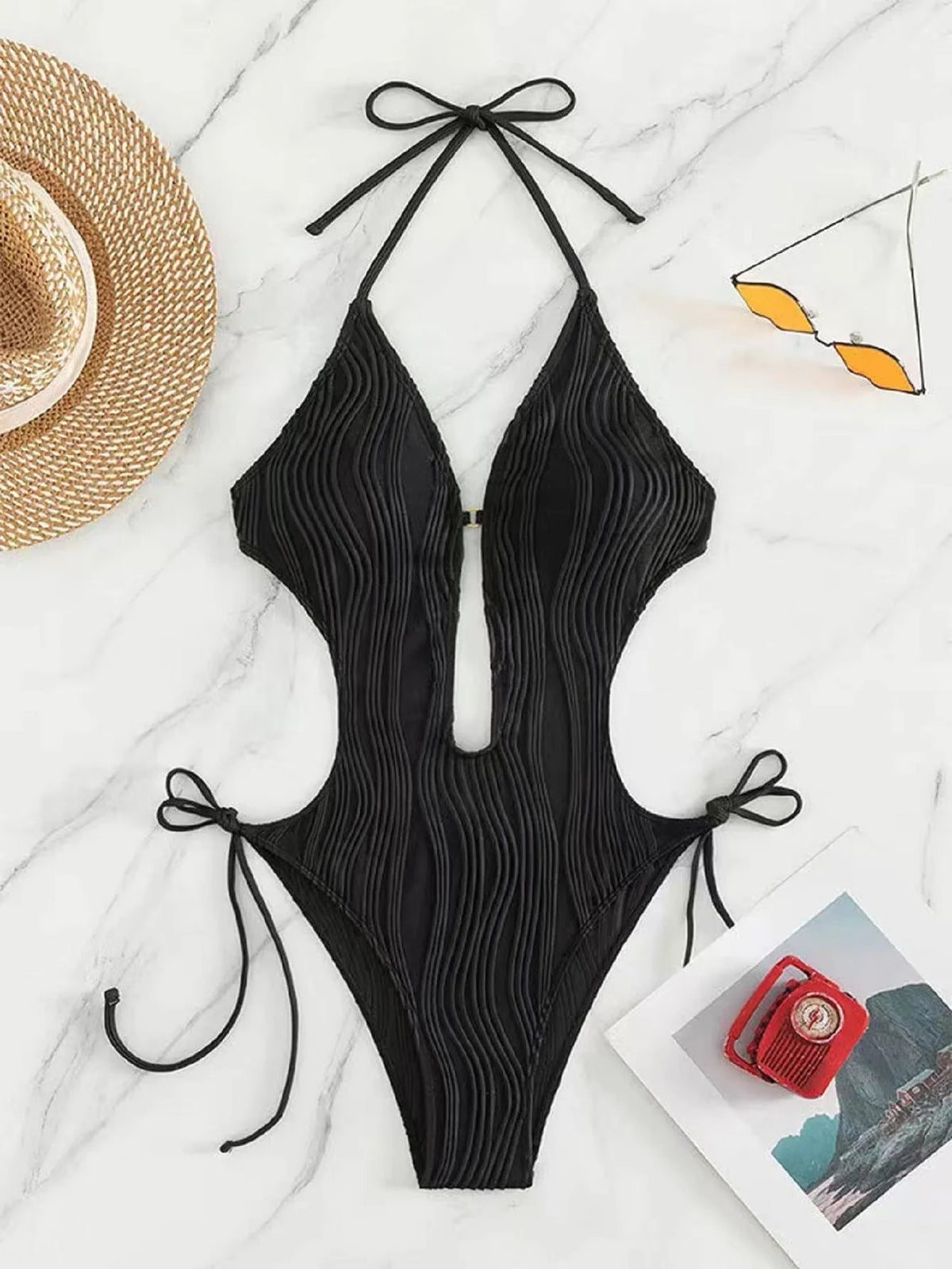 Women's black lace-up triangle bikini swimsuit on a mannequin, front view.
