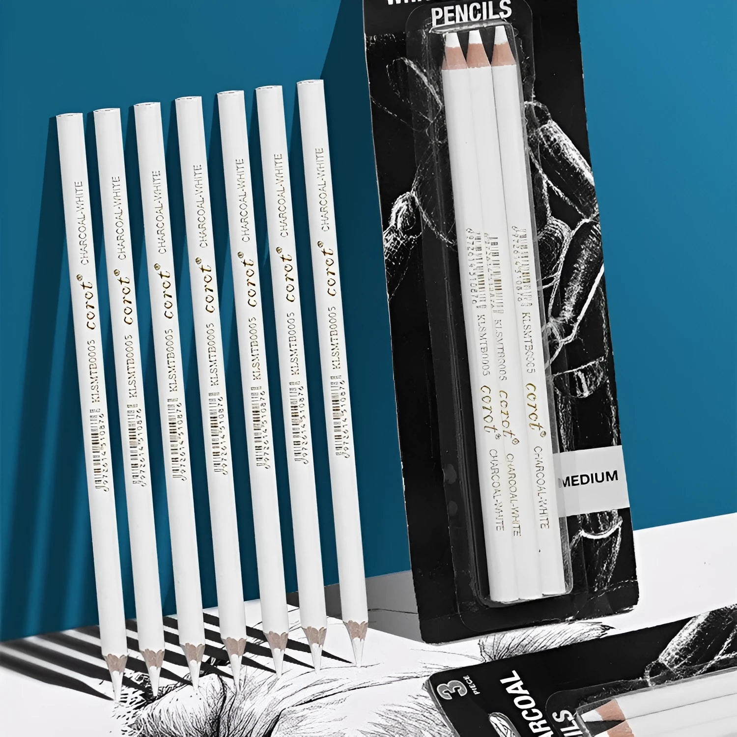 Set of three white charcoal pencils with wooden shells for highlighting and shading art on dark paper