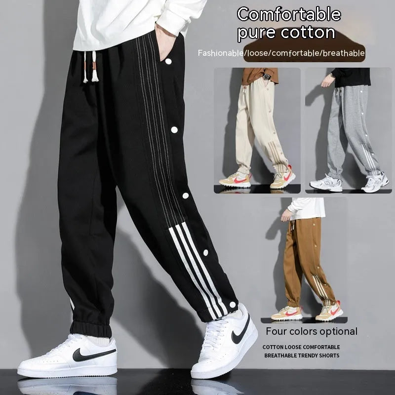 Men's loose fit ankle-tied sports pants in black with drawstring waist and elastic cuffs