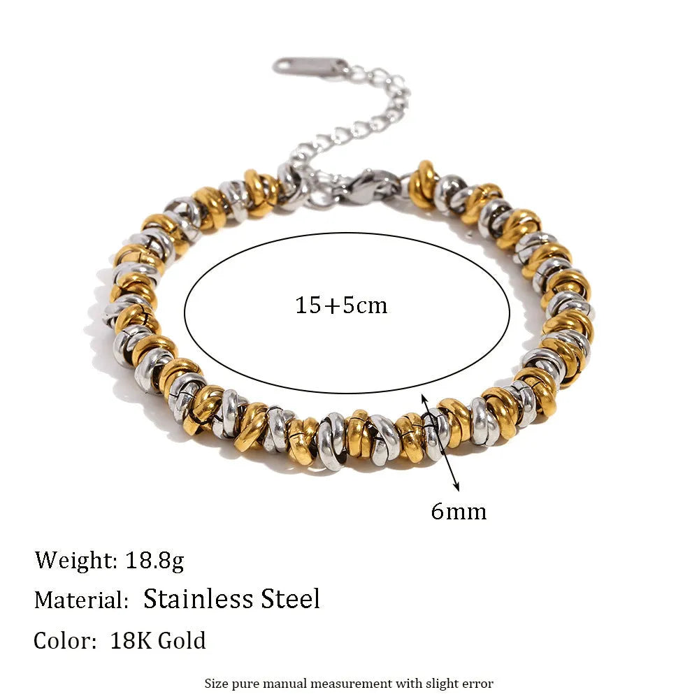 Gold electroplated jewellery set showing geometry-designed earrings, bracelet and necklace on stainless steel