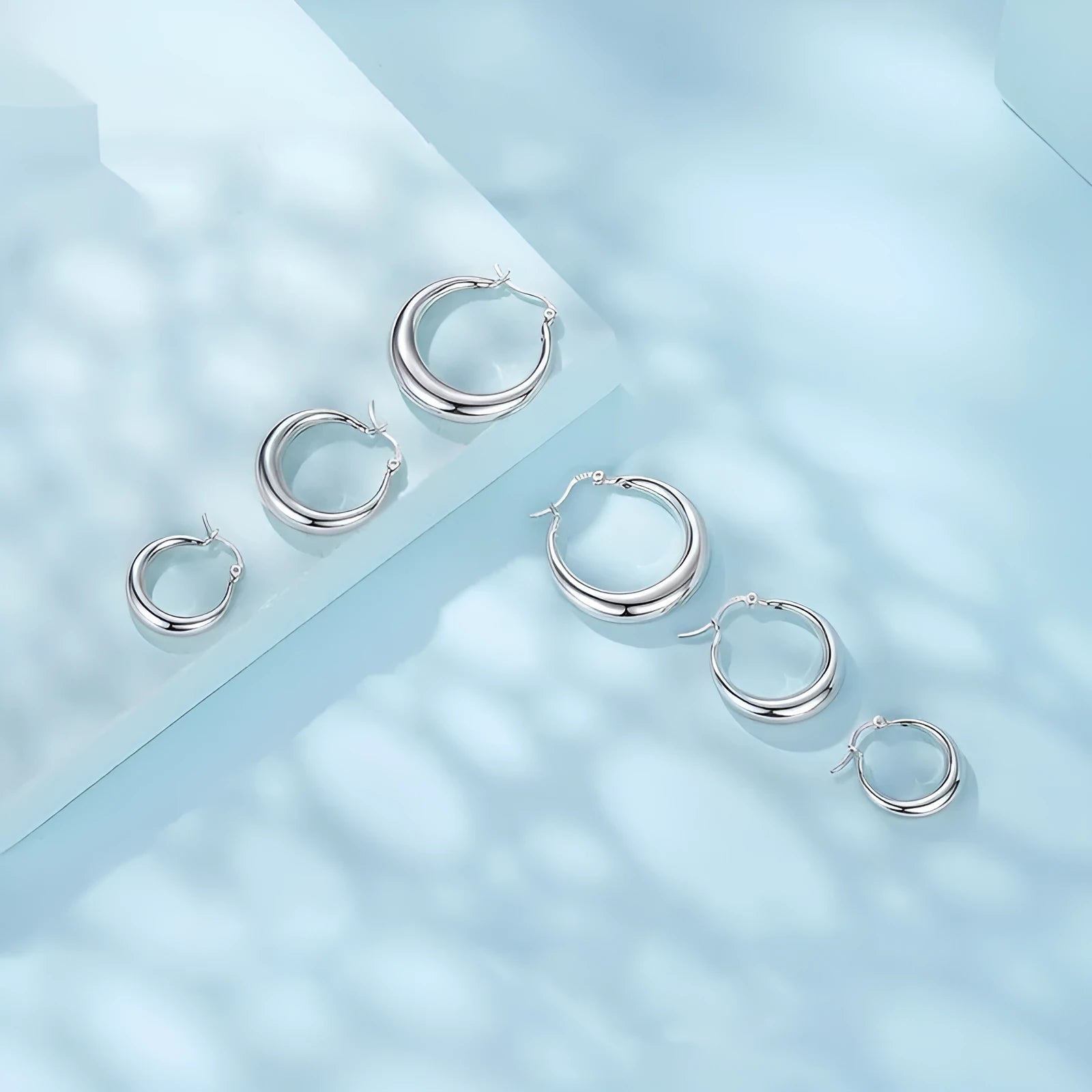 Copper alloy geometric ring ear clip earrings with silver needle closure in three size options
