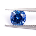 Royal blue love-shaped tiara cultivation gemstone in heart, round, and pear shapes on a jeweller's cloth.