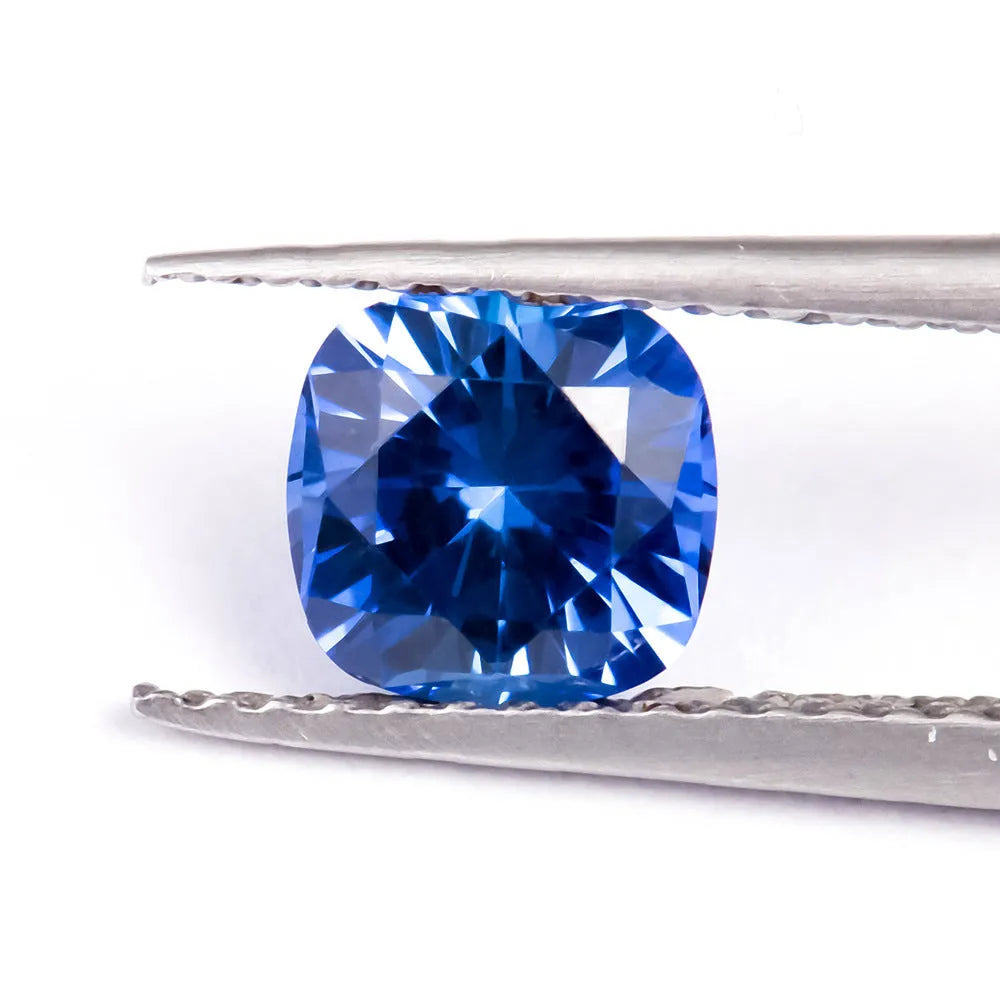 Royal blue love-shaped tiara cultivation gemstone in heart, round, and pear shapes on a jeweller's cloth.