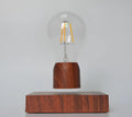 Magnetic levitation floating light bulb with imitation wood base and glass enclosure