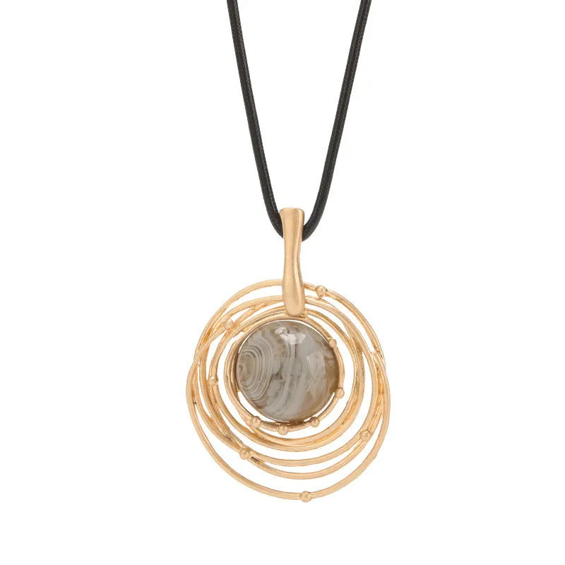 Gold geometric plaid pendant necklace with a textured snakeskin wax rope chain.