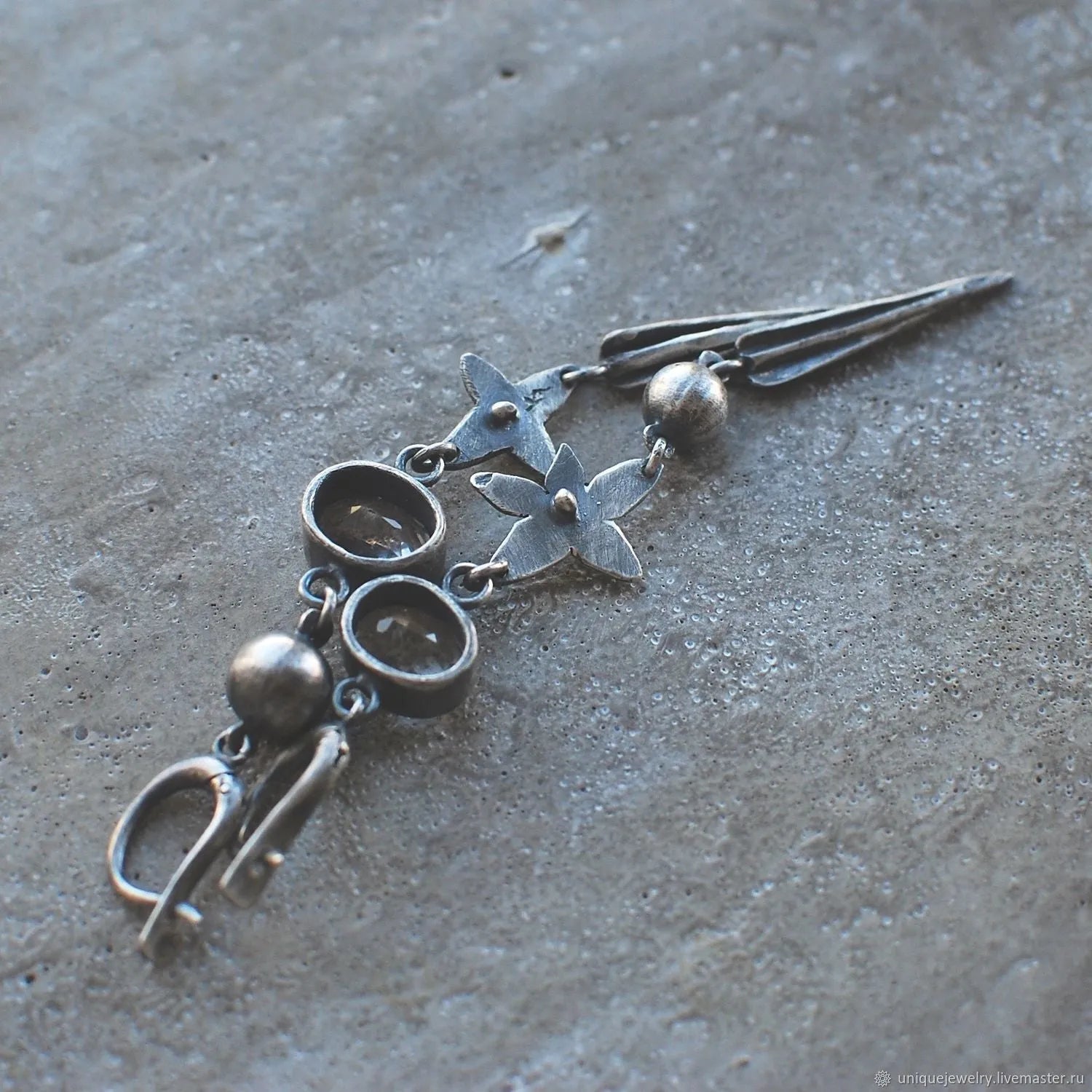 Geometric long pendant earrings in antique silver with rhinestone details on a stud.