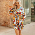 Orange floral print mini dress with V-neck, long sleeves, and striped lace trim