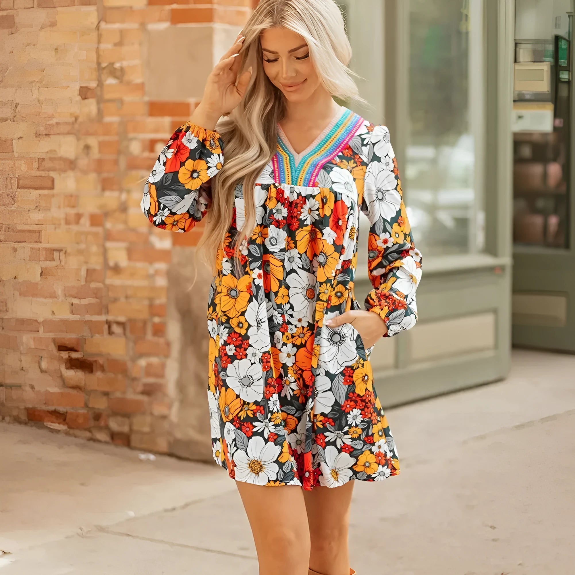 Orange floral print mini dress with V-neck, long sleeves, and striped lace trim
