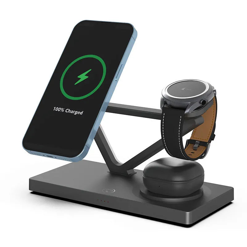 White five-in-one wireless charging station with magnetic phone bracket, circular charger, watch pad, and night lamp on desk.