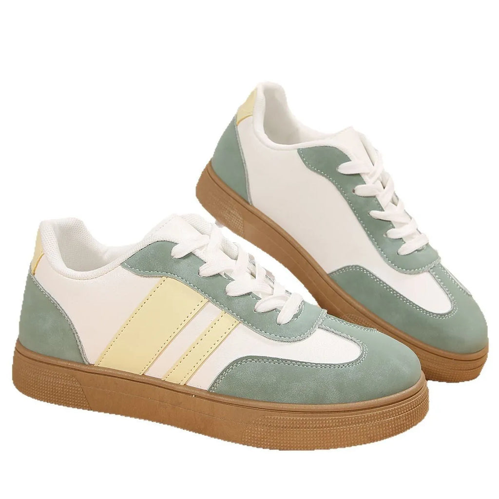 Green women's retro sports shoes with white cross straps and a low flat heel