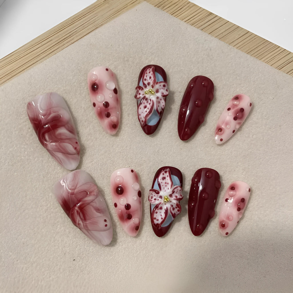 Almond colour artificial nails with 3D carved floral designs including roses and tulips