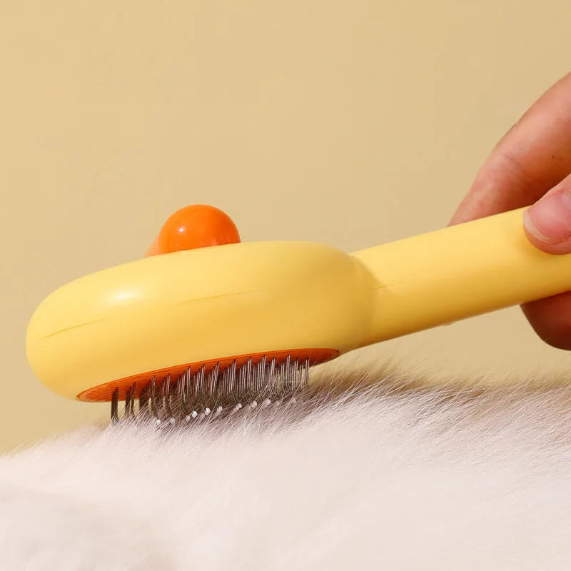 Small yellow cat grooming comb with needle teeth and floating hair removal device