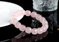 Close-up of a pink crystal barrel bead bracelet with 11-12mm beads on a wrist.