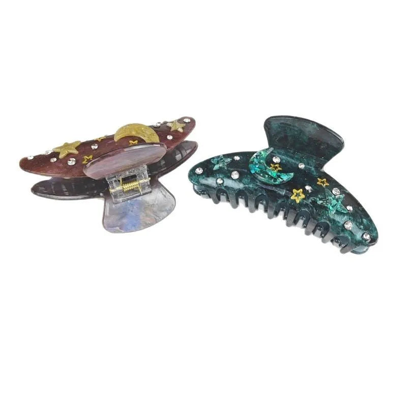 Oversized women's hair barrette with star and moon celestial design in starry sky colour options